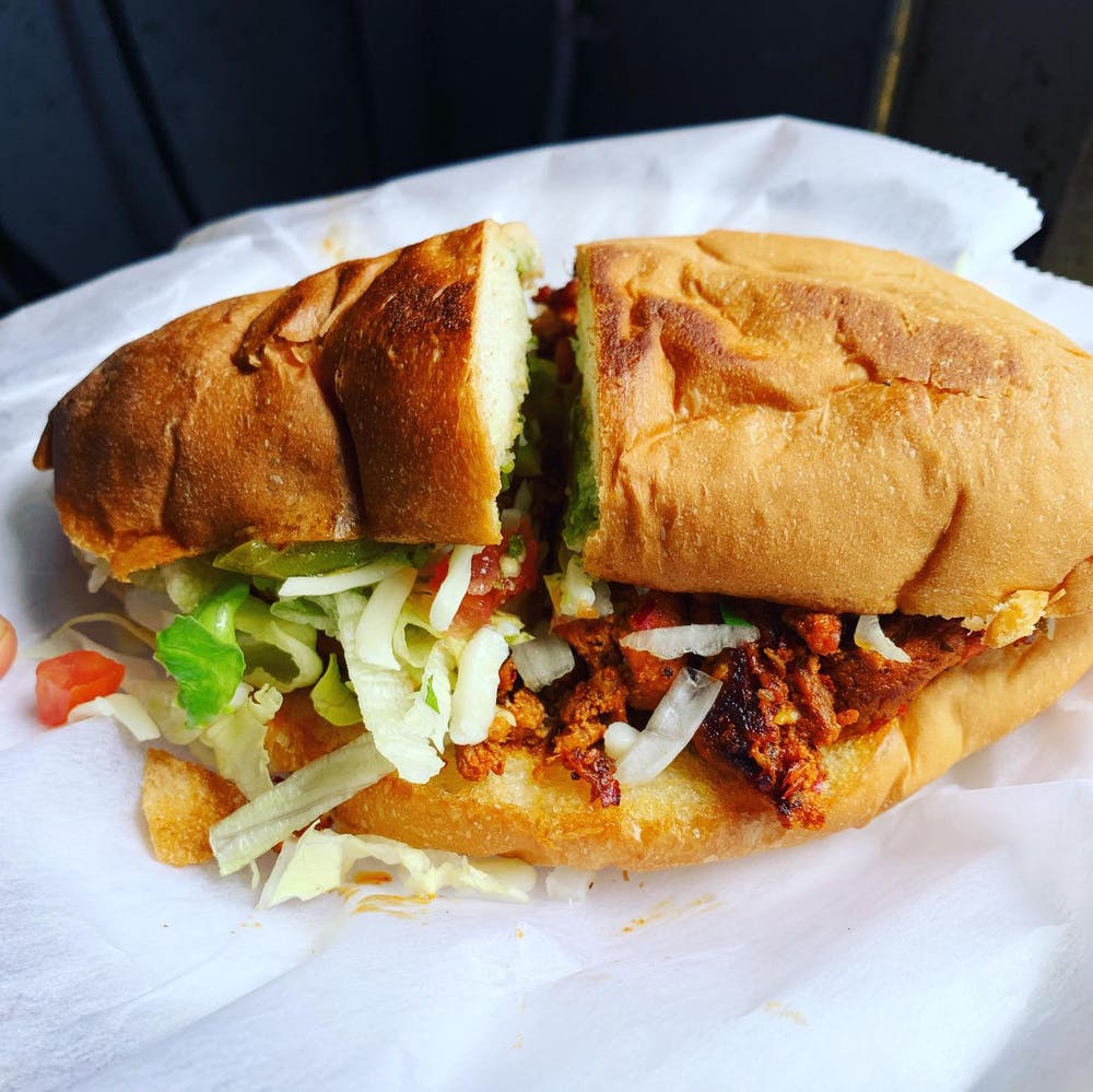 a sandwich sitting on top of a paper plate